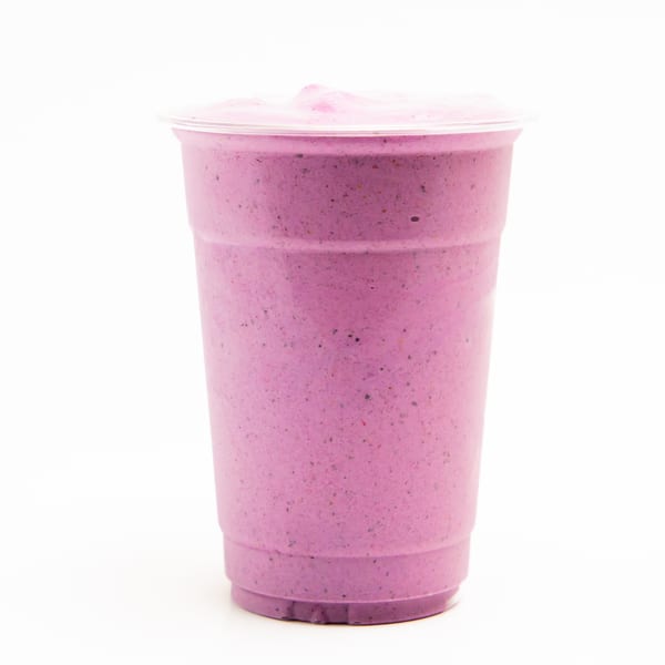 A vibrant purple Superfood Cafe smoothie in a clear plastic cup with a domed lid.
